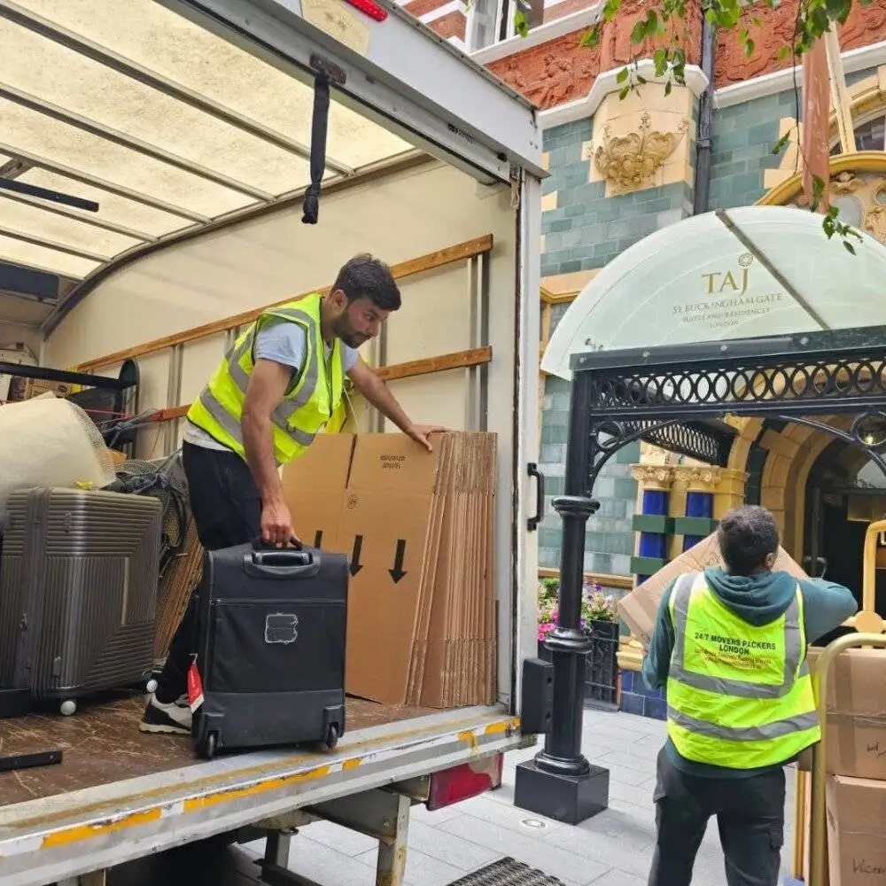 Two workers of 24/7 Movers Packers London are unloading the trucks from packed items