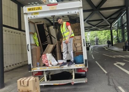 A worker of 24/7 Movers Packers London is loading packed stuff in the moving van